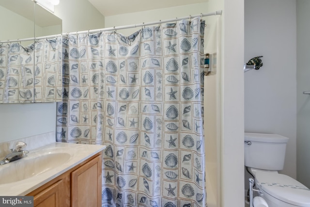 bathroom featuring a shower with curtain, toilet, and vanity