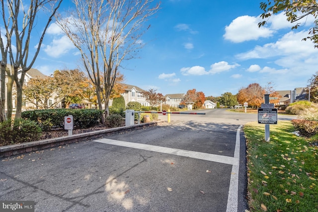 view of road with a residential view and a gated entry