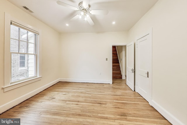 empty room with visible vents, light wood-style flooring, a ceiling fan, recessed lighting, and baseboards