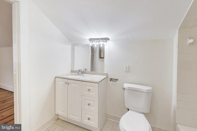 bathroom with toilet, tile patterned flooring, a shower, baseboards, and vanity