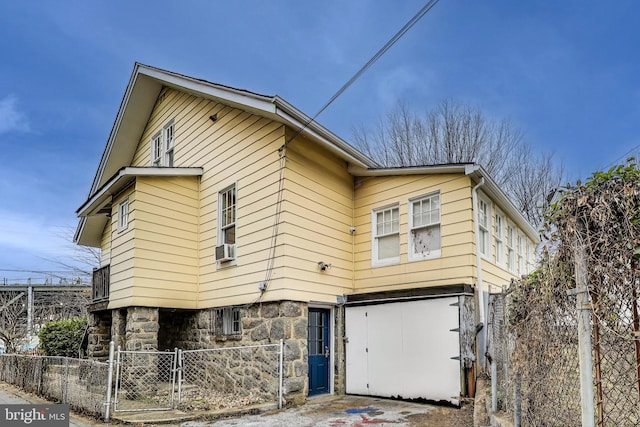 view of front of home with a gate, fence, and cooling unit