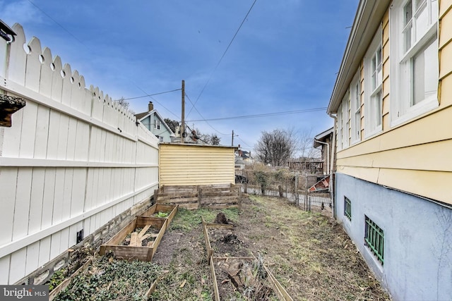 view of yard featuring a vegetable garden and a fenced backyard