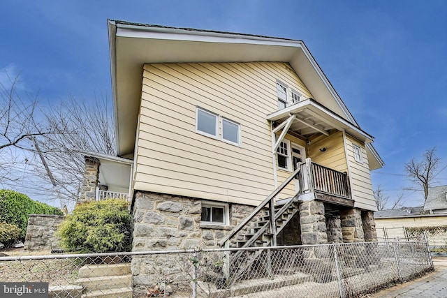 1319 Decatur St NW, Washington, DC 20011 - view of side of property featuring fence, stairs, and stone siding
