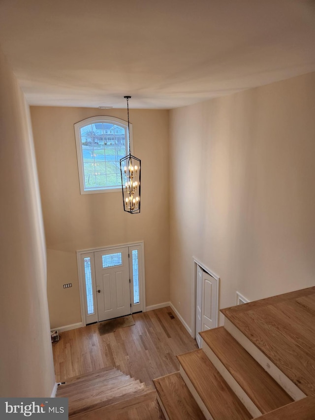 240 Banyan Dr, State College, PA 16801 - entrance foyer with stairs, wood finished floors, baseboards, and a chandelier