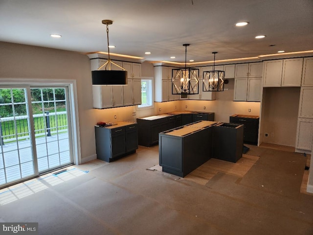 240 Banyan Dr, State College, PA 16801 - kitchen featuring recessed lighting, a center island, baseboards, and an inviting chandelier