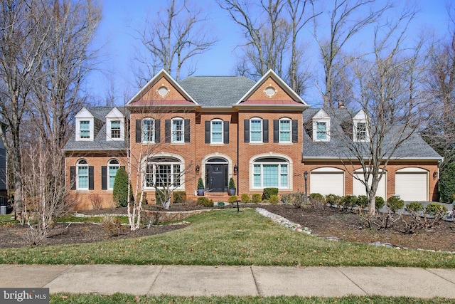 colonial inspired home featuring brick siding and a front lawn