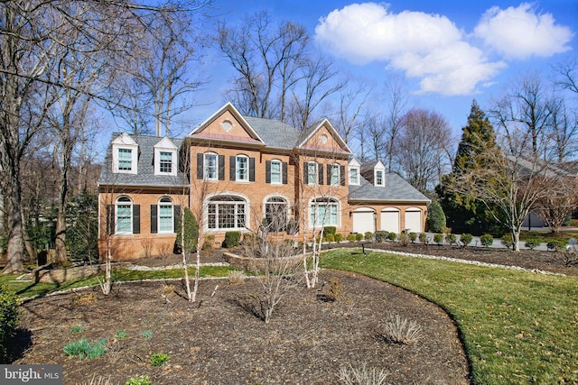 colonial home featuring a front yard, brick siding, and driveway