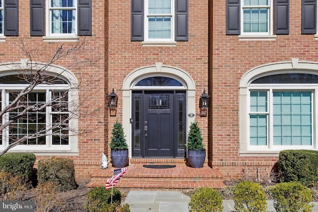 property entrance with brick siding