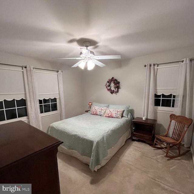 bedroom featuring light colored carpet and ceiling fan