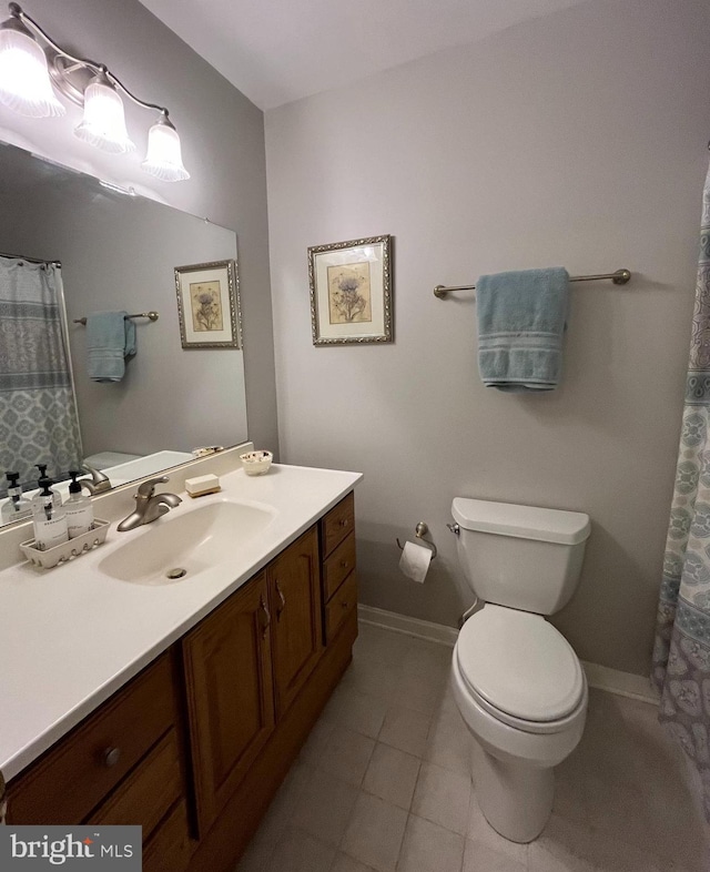 full bathroom with baseboards, toilet, vanity, and tile patterned flooring