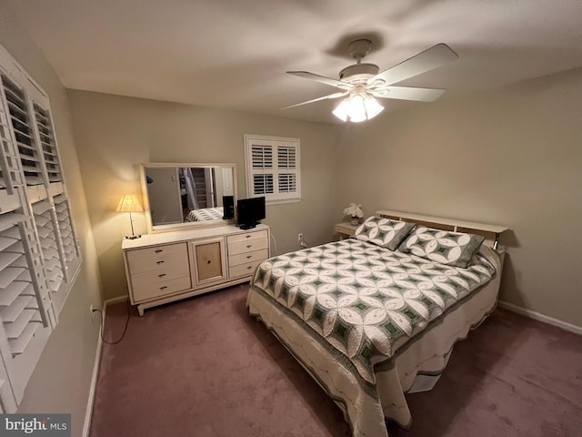 bedroom featuring ceiling fan, baseboards, and dark colored carpet