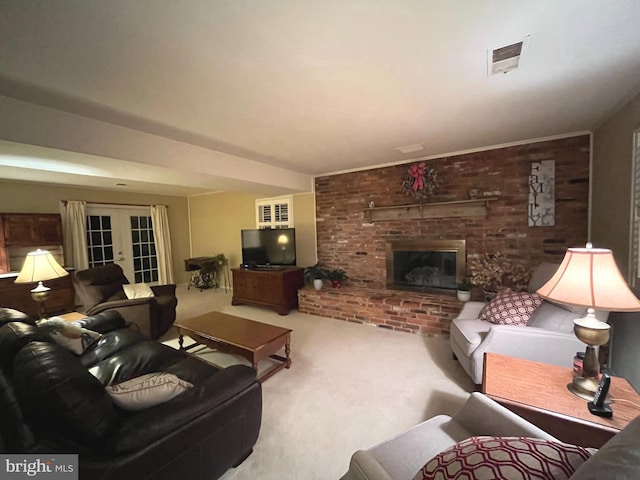 carpeted living area featuring a brick fireplace, french doors, visible vents, and brick wall