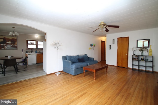 115 Crestmont Ave, State College, PA 16801 - living room featuring arched walkways, light wood-style flooring, ceiling fan with notable chandelier, and baseboards