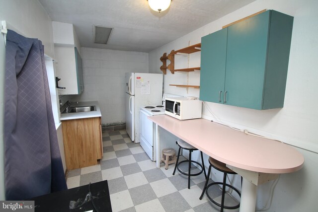 115 Crestmont Ave, State College, PA 16801 - kitchen featuring a sink, light floors, white appliances, concrete block wall, and open shelves