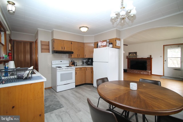 115 Crestmont Ave, State College, PA 16801 - kitchen with light wood finished floors, under cabinet range hood, light countertops, an inviting chandelier, and white appliances