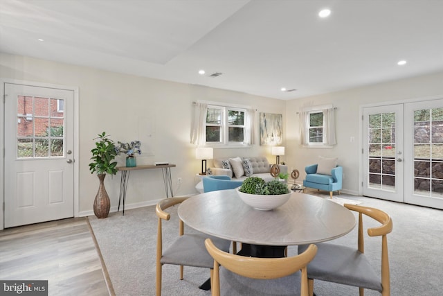 dining room featuring visible vents, baseboards, light wood-type flooring, recessed lighting, and french doors