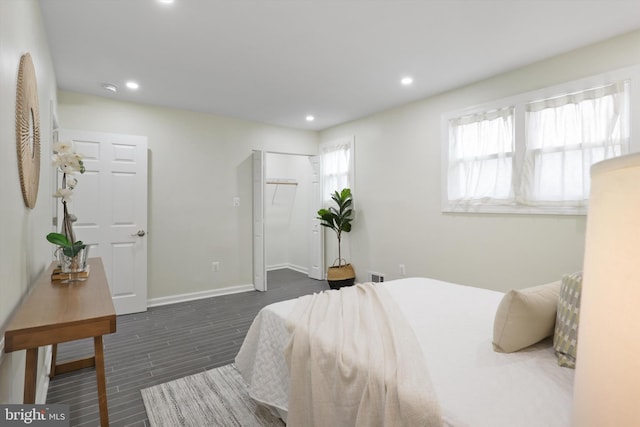 bedroom with recessed lighting, multiple windows, and dark wood-style floors