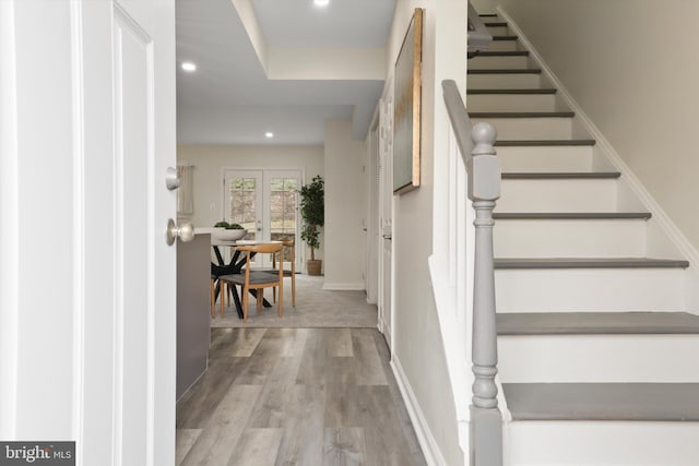 interior space featuring recessed lighting, baseboards, and wood finished floors