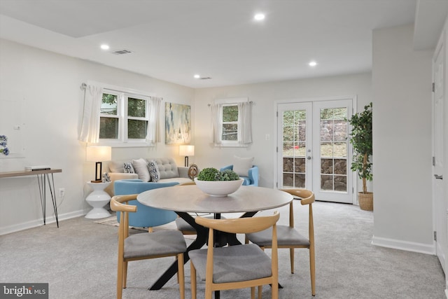 dining room featuring baseboards, visible vents, recessed lighting, french doors, and light carpet