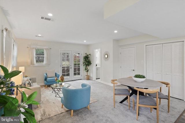 carpeted living area with recessed lighting, visible vents, baseboards, and french doors