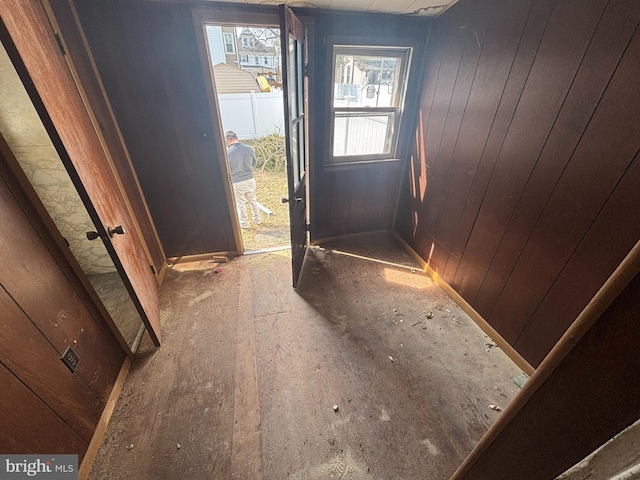 entryway featuring wood walls