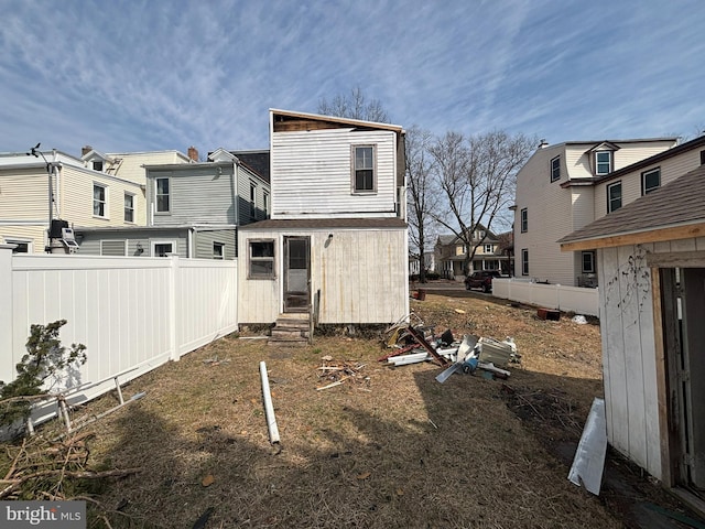 rear view of property with a residential view, fence, and entry steps