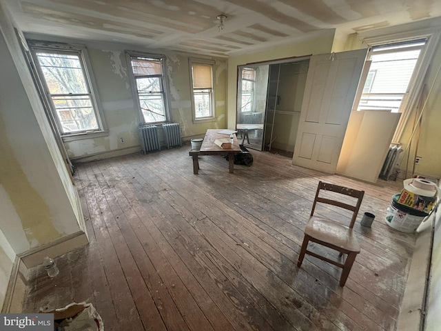 interior space featuring hardwood / wood-style flooring, radiator, and baseboards