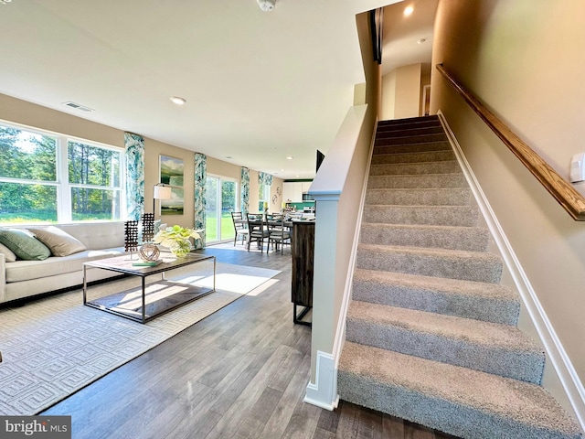 staircase with visible vents, recessed lighting, baseboards, and wood finished floors