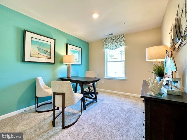 carpeted office featuring visible vents and baseboards