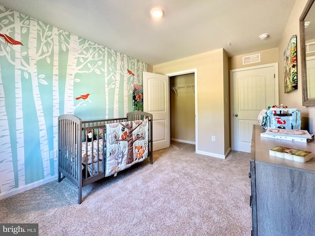 bedroom featuring carpet, visible vents, a closet, and baseboards