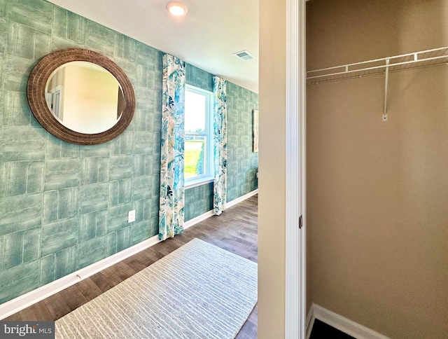 interior space featuring wood finished floors, visible vents, and baseboards