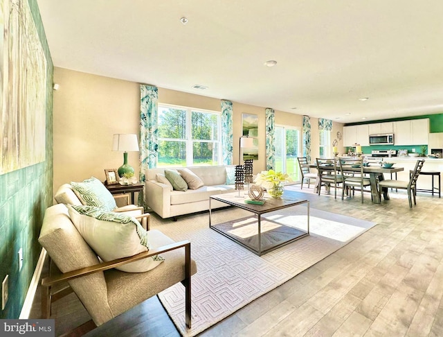 living area featuring visible vents and light wood-type flooring