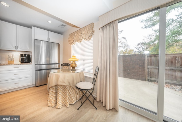 dining area with recessed lighting, a healthy amount of sunlight, and light wood finished floors