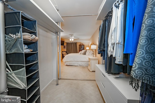 spacious closet with a ceiling fan and light floors