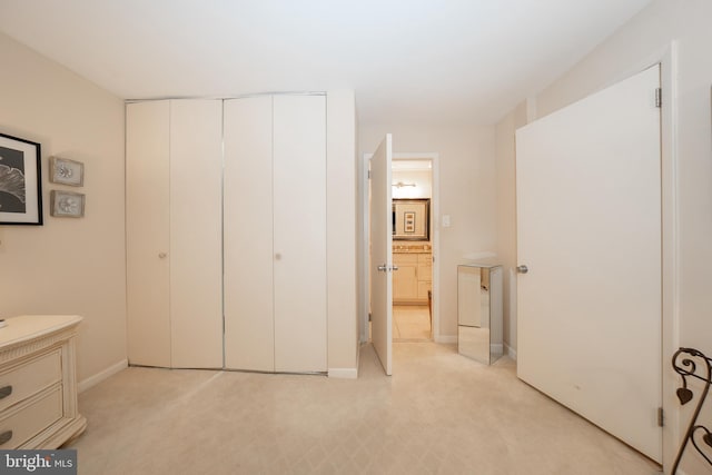 bedroom with baseboards and a closet