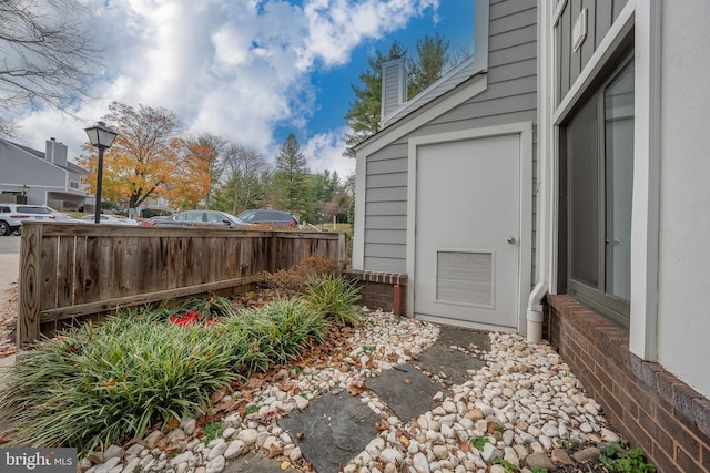 exterior space with visible vents and fence