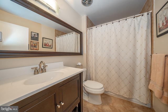 full bath with vanity, toilet, visible vents, and tile patterned flooring