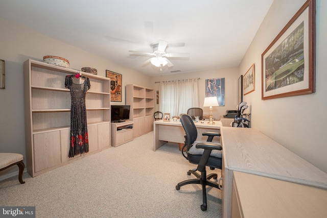 carpeted home office with ceiling fan