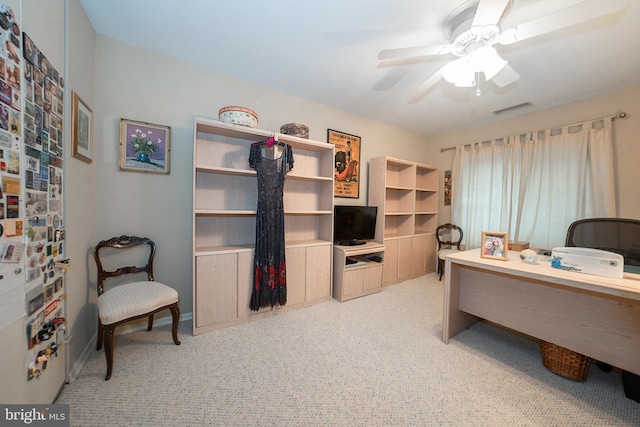 office space with baseboards, visible vents, and ceiling fan