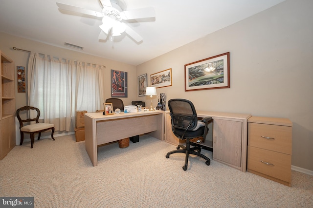 office featuring visible vents, light colored carpet, and a ceiling fan