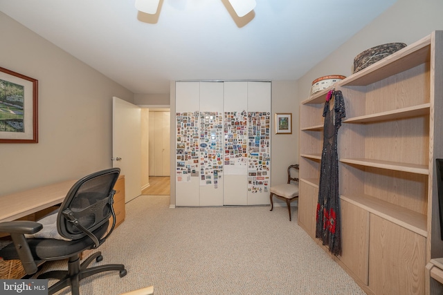 office space featuring ceiling fan and light carpet