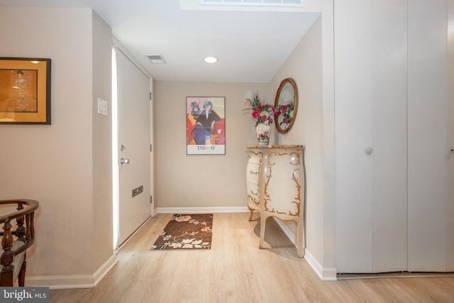 interior space with visible vents, light wood-style flooring, and baseboards