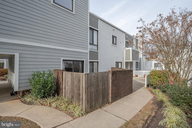 view of home's exterior with fence