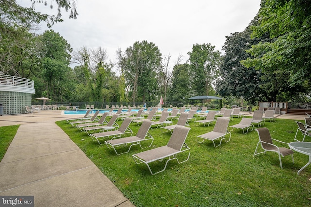 view of yard with a community pool and fence