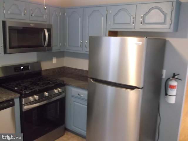 kitchen featuring dark countertops and appliances with stainless steel finishes