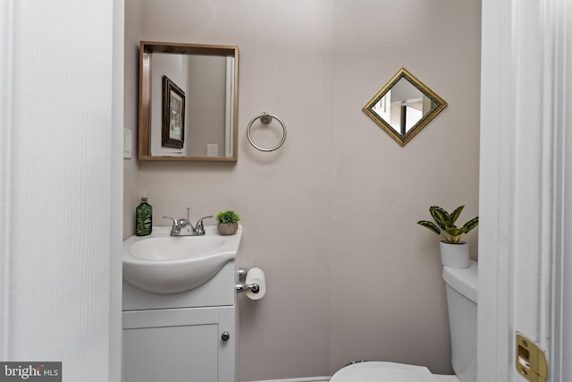 bathroom featuring toilet and vanity