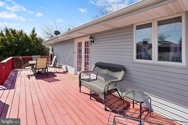 deck featuring outdoor dining area and french doors