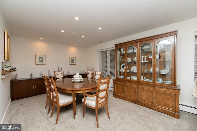 dining room featuring a baseboard heating unit, recessed lighting, light colored carpet, and baseboards