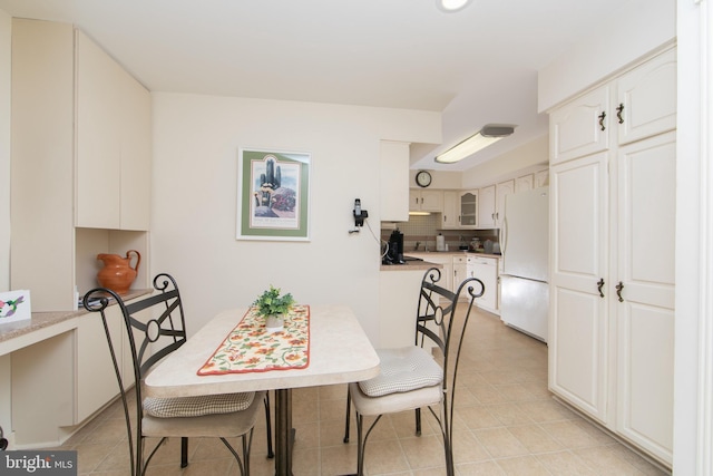 dining area featuring light tile patterned floors