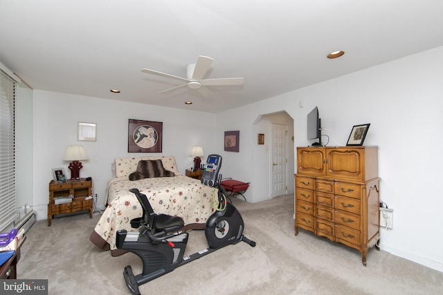 bedroom with recessed lighting, light carpet, arched walkways, and ceiling fan